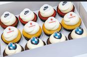 12 Cupcakes with icing sugar logo image