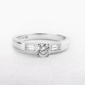 0.59ct Round Cut Natural Diamond Solitaire With Baguette Side Diamonds Set In 18ct White Gold