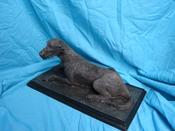 "Did Someone Call" Irish wolfhound sculpture lying down but alert. image