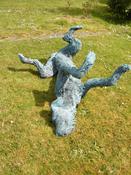 "On A Roll" Irish wolfhound sculpture rolling on the ground. image