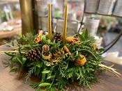 A Christmas Fresh Table Centrepiece Display with Church Candle