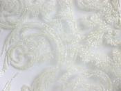 Cream glitter iron-on scroll on white net