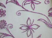Cerise glitter iron-on flower on black net image