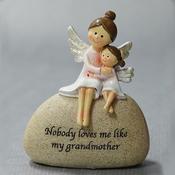Angel grandmother with granddaughter on stone