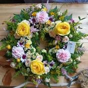Pink and yellow funeral wreath image