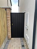 Metal framed side entrance gate.