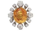 Modern 6.52ct fancy yellowish orange sapphire and old cut diamond cluster ring image