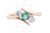 EDWARDIAN EMERALD AND DIAMOND THREE-STONE CROSSOVER RING, 1909 image