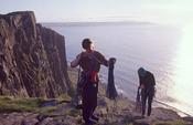 Rock climbers at the cliffs of Fair Head, Co Antrim, Northern Ireland.