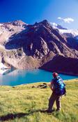 Walker looking over the Grunasee and Wilder Freiger, Stubai Hohenweg, Tirol, Austria.