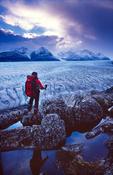 Trekker looking over Glacier Grey, Paine Circuit, Torres del Paine NP, Patagonia, Chile.