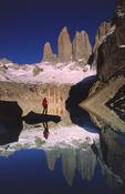 Reflection of trekker and the Torres del Paine, Torres del Paine NP, Patagonia, Chile. image