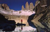 Reflection of trekker and the Torres del Paine, Torres del Paine NP, Patagonia, Chile. image
