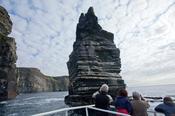 Tourists admiring the Cliffs of Moher from a scenic boat tour, Co Clare, Ireland. image