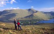Walkers looking to the Partry Mountains from Ben Gorm, Connemara, Co Galway, Ireland.