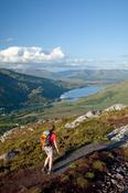 Walker climbing Diamond Hill, Connemara National Park, Co Galway, Ireland.