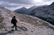 Walker in the Twelve Ben Mountains, Connemara, County Galway, Ireland.