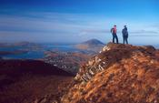 Walkers at the summit of Diamond Hill, Connemara National Park, Co Galway, Ireland.