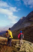 Walkers beneath Bencollaghduff Mountain, Twelve Bens, Connemara, County Galway, Ireland.