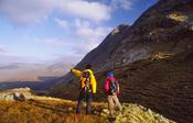 Walkers looking towards Bencollaghduff, Twelve Bens, Connemara, Co Galway, Ireland.
