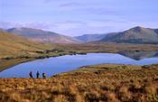 Walkers on the shore of Lough Fee, Connemara, Co Mayo, Ireland.