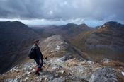 Descending the narrow ridge from Bencollaghduff to Maumina, Twelve Bens, Connemara, Co Galway, Ireland.