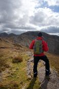 Walker near the summit of Benbaun, Twelve Bens Mountains, Connemara, Co Galway Ireland.