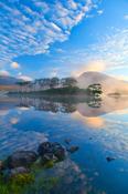 Misty morning reflection of the Twelve Bens in Derryclare Lough, Connemara, Co Galway, Ireland.