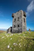 Hiker and signal tower at the summit of Cnoc Bolais, Dursey Island, Beara Peninsula, County Cork, Ireland.