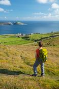 Hiker above the hamlet of Ballynacallagh, Dursey Island, Beara Peninsula, County Cork, Ireland.