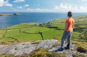 Hiker above the hamlet of Ballynacallagh, Dursey Island, Beara Peninsula, County Cork, Ireland.