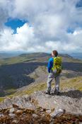 Hiker looking over the Beara Peninsula from the summit of Hungry Hill, County Cork, Ireland.
