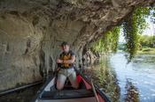 Canoeist beneath a limestone cliff, Blackwater River, Mallow, County Cork, Ireland.