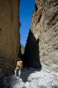 Hiker beneath the Iron Gates, Samaria Gorge, Samaria National Park, Crete, Greece.