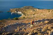 Hiker on a path high above Loutro village, White Mountains, Crete, Greece. image