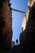Hiker silhouetted at the base of the Aradena Gorge, White Mountains, Crete, Greece.