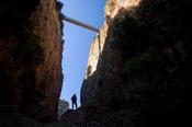 Hiker silhouetted at the base of the Aradena Gorge, White Mountains, Crete, Greece.