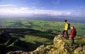 Walkers on the cliff tops of Binevenagh, Co Derry, Northern Ireland.