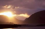 Sun breaking through storm clouds over Lough Veagh, Glenveagh National Park, Co Donegal, Ireland.