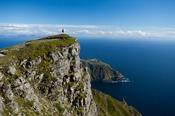 Walker looking towards Bunglas from close to the summit of Slieve League, County Donegal, Ireland.