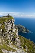 Walker looking towards Bunglas from close to the summit of Slieve League, County Donegal, Ireland.