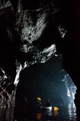Sea kayaker in a cave beneath the Slieve League cliffs, County Donegal, Ireland.