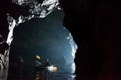 Sea kayaker in a cave beneath the Slieve League cliffs, County Donegal, Ireland.