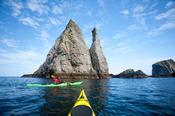 Sea kayaker exploring seastacks near Port, County Donegal, Ireland.