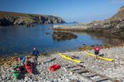 Sea kayakers preparing for departure, Port, Glencolmcille, County Donegal, Ireland.