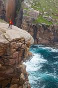 Hiker admiring the rocky coastline of Owey Island, The Rosses, County Donegal, Ireland. image