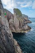 Rock climber on the eastern shore of Owey Island, County Donegal, Ireland.