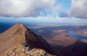 Walker at the summit of Errigal Mountain, Co Donegal, Ireland.