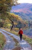 Walker on a track beside Lough Veagh, Glenveagh National Park, County Donegal, Ireland.