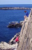 Rock climbers on Hydrophobia, VS 4b, Malin Beg, Co Donegal, Ireland.